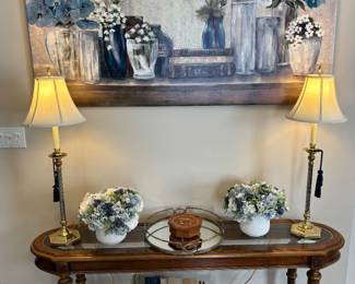 Beautiful accent table, brass lamps, books, artwork