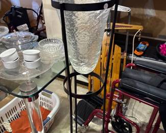 blown glass vase with wrought iron frame for plants 