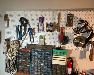 Various tools, including grease guns, saws, saw blades, ropes, 3 organizers with various items included.
