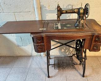 Antique White Sewing Machine Number OF In Original Wood Cabinet With Iron Foot Pedal
Lot #: 22