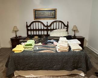 King Size bed with side tables, dresser, mattress, sheets, green quilt.