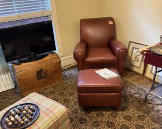 leather chair with ottoman. Old wooden chest. Roku TV.