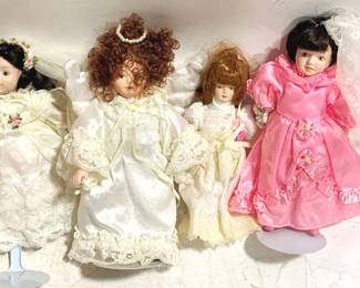 3336 - 4 Porcelain dolls - 9" tall some w/ stands
