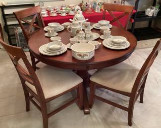 Ashley round dining table with four chairs and butterfly leaf