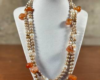 An artisan made necklace with multi-colored Tourmalines, sterling silver, & “Peacock” Tahitian Pearls. In excellent condition, this necklace can be layered over or worn as is, with a total length of 44”. Peacock Pearls are said to bring centering and a calming reflection, as well as attune the wearer to the ebb and flow of life.