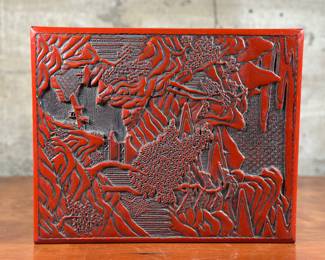 A late 19th century lacquer & hand-carved varnished wood cinnabar box in very good condition. This decorative box with lid measures (closed), 5” H x 13” W x 10.75” D. A cinnabar box is a type of antique Chinese lacquerware box, typically made with a rich red lacquer, known for its intricate carvings and often used for holding keepsakes or small items.