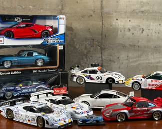 This lot features a large collection of racing model cars with a total of 10 cars in this lot. Some of the makers include Maisto, UT Models, and more. One car has a side mirror that has been broken off as shown in photos (part is present) and one car has two missing wheels (one available to reattach).