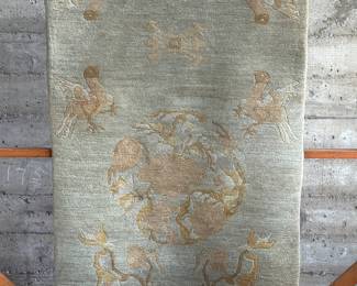 An antique hand-knotted woolen carpet made in Nepal. Maker tags present underneath as shown in photos. This hand-knotted woolen carpet from Nepal measures, 76” x 36”. A hand-knotted carpet from Nepal is a rug made by hand using a traditional weaving technique. They are often called Tibetan carpets.