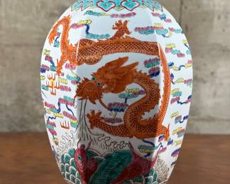 A large antique lidded Chinese porcelain vase, signed underneath as shown in photos. The lid has been repaired, please see photos for condition. This vase features beautiful detail including a octagonal shape and dragons throughout. This vase measures 12” H x 9” W x 9” D.