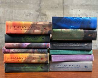 A collection of 12 Harry Potter hardcover books in various conditions. At least two of them contain known printing errors.