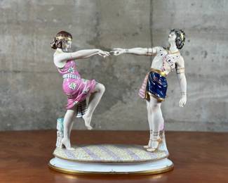 A large porcelain figure of a dancing couple on an oval base with high-quality polychrome painting, circa 1920s, manufactured by Aelteste Volkstedt. Aelteste Volkstedt is the name of a porcelain factory in Rudolstadt, Germany that was established in 1762. It is the oldest working porcelain factory in Thuringia. This large porcelain figure measures, 13.5” H x 12” W x 7” D.