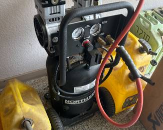 Air compressor with mounted hose reel