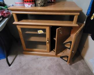 Medium-sized television cabinet with storage, glass door. 