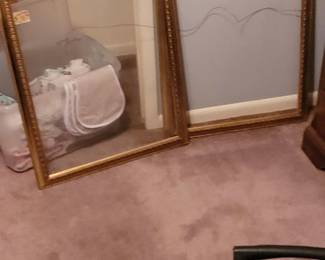 Large gold-framed picture frames.