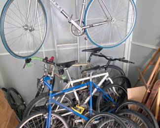 Assorted bicycles + standing bike rack; bike seats + gear also available.