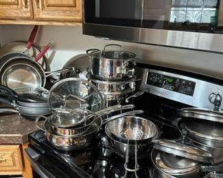 Across the kitchen on the stove is a set of BEAUTIFUL pots and pans! In near perfect condition! 