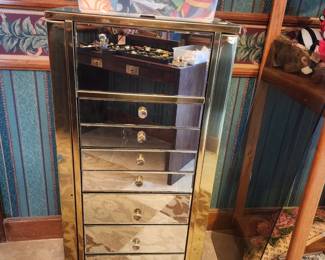 Mirrored jewelry box with side drawers.