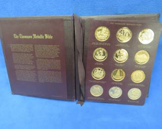 Lot 252. 1970 Franklin Mint Thomason Medallic Bible complete coin set in original binder. 60 solid bronze coins depicting Biblical scenes.
