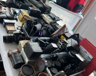 Camera collection with lenses, bags, and accessories. 