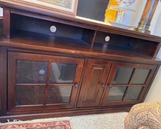 Sideboard or TV stand has the slots for the TV two glass front doors with a small middle door
Shelf on each side! Well-made!