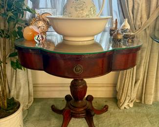 Antique leather top clover pedestal table and antique pitcher with basin 