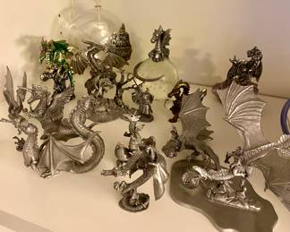 Dozens of dragon figurines. These are pewter. There are also ceramic, clay and glass pieces in later photos.