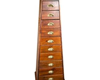 PYRAMID CHEST OF DRAWERS | Interesting wood chest of drawers in pyramid/trapezoid shape with 10 graduating drawers with brass seashell pulls. - h. 58.5 x w. 20.25 x d. 16 in
