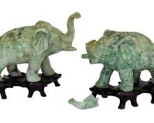 Pair of Antique Carved Jade Elephant Figurines / Antique Chinese Cheng Lung Dynasty Carved Jade Elephant Figurines 

Cheng Lung Dynasty- 1736-1795

Very fine carvings of two Trumpet Trunk Elephants, carved from solid pieces, mounted on rosewood bases. 

The tallest elephant measures about 4.5" w x 4" h 

As seen in the photo gallery, one of the elephants sadly, has a broken trunk 
