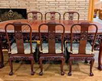 Gorgeous Carved Rosewood Dining Set Inlaid with Mother of Pearl Dragon Motif. Includes seating for eight and two additional leaves.

The tabletop has a few faint marks but in otherwise great condition. No manufacture marks were found.

The table measures 95” x 44” and 21” high.