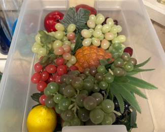 Bin of faux fruit 