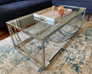 Glass coffee table. There are two matching side tables. 