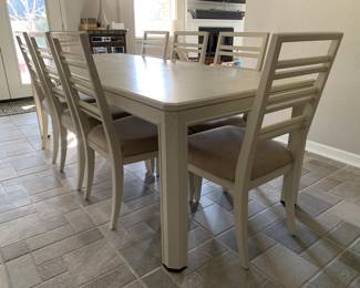 Dining table with upholstered chairs, seats 8