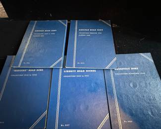 Coin books with some coins