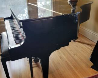 A 70" Sojin Piano in Ebony. 