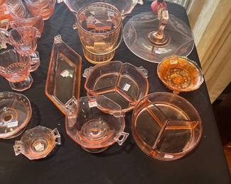 Table full of pink depression glass