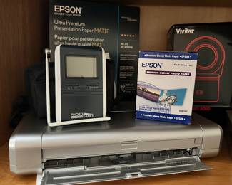 Pixma iP100 Series Compact Photo Printer Shown with a Digital Photo Safe II, Epson Premium Glossy Photo Paper, Vivitar Macroflash 5000 and Epson Ultra-Premium Matte Presention Paper.