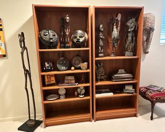 Fantastic Collection of African Tribal Masks and Statues Available Shown on a Pair of Solid Wooden Bookshelves, 32.5"W x 12.5" x 76"H, Shown with a African Senufo Rythm Pounder Female Figure, 62"H.