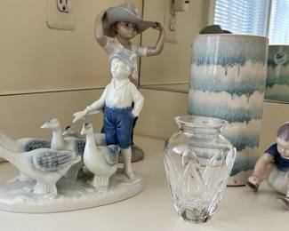 Unique Selection of Porcelain Figurines Including a Royal Copenhagen B&G "Dickie Boy", NAO by Lladro Boy With Cowboy Hat Statue, and a Gerold Porcelain Farm Boy with Geese Flock Figurine #7154 from West Germany. Also Available are a Leif Shop Signed Ceramic Vase and Waterford "Posey" Bud Vase.