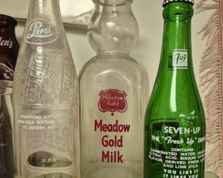 St. Joseph bottles.  Pepsi, 7-Up and Meadow Gold Milk