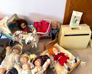 Vintage dolls, stroller and bed.
Old Singer portable sewing machine.