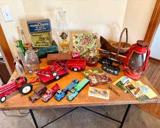 Antique French table with iron base,  Antique toys, railroad lantern, Sicilian tile, tobacco tins, old bottles
