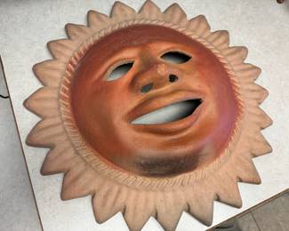 Large terracotta sun face