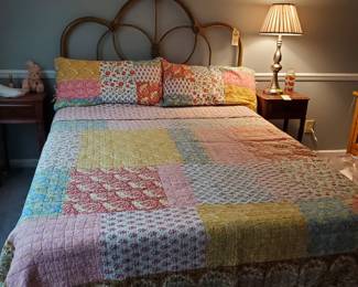 Iron full bed and vintage coverlet.