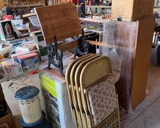 Antique school desk. Reupholstered folding chairs. New water fountain yard feature. Old oil stove case. 