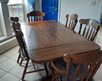 Large solid wood table w/ 6 chairs and 2 leafs