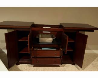 Opens up w/ ice bucket inside along w/ drawers for storage