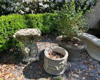 Wonderful assortment of garden planters, wall art, and garden furniture