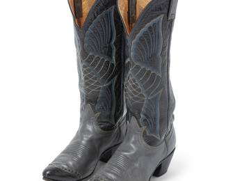 276
A pair of vintage Tony Lama two-tone leather Western boots
Late 20th century
Each marked for maker and size
Comprising a pair of black and grey leather boots with contrast black lizard toes and elaborate contrast stitching in blue, white and grey (size 7B; style No. 7518), 2 pieces
Each: 15.5" H; heel: 2.25"
Estimate: $50 - $75