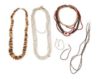 333
A group of bead strands and stone necklaces
Late 19th century and later
Comprising six strands of white beads, three strands of red and white glass "white heart" beads of various sizes, each on string, and three strands of fine dark heishi, as well as a chunky graduated bone tab necklace, a graduated greenstone strand with pipestone and clam beads and silver bead clasp, and a collar necklace of shell discs, 15 pieces
Largest: 26.5" L; smallest: 7.5" L
389.0 grams gross
Estimate: $100 - $200