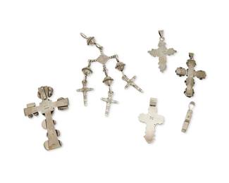 298
A group of Southwest-style cross pendants
Mid/late 20th century
Variously marked for maker and for sterling
A Gilo and Grace Nakai Navajo/Diné large sterling silver and set turquoise and gemstone cross pendant, a small OJ sterling silver and set gemstone pendant, a small DA double sided stone inlay pendant, and two Mexican sterling silver crosses, one with silver roses, and one with filigree wire overlay, as well as a
Colonial-style triple-cross pendant with silver balls, 6 pieces
Largest: 6" H x 2.5" W; smallest: 1.75" H x 1" W
178.3 grams gross
Estimate: $500 - $700